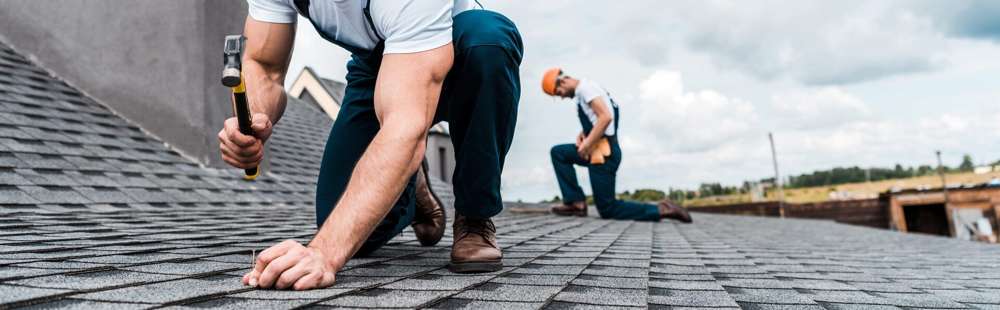 Roofers installing shingles on an Austin home